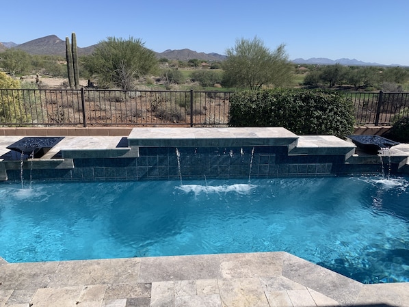 Backyard private pool with golf course and mountain views.