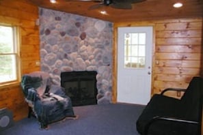 Bass Bunk living room with stone gas fireplace