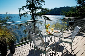The Suite waterfront deck has dining for 4 guests,  BBQ, zero gravity chairs