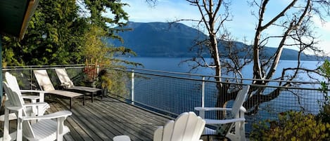 Expansive Waterfront Decks with lounge seating, dining & BBQ