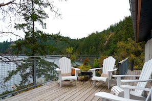 Comfortable Adirondack chairs for seaside deck lounging. 