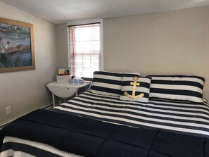 King size bed with a peekaboo lake view and smart tv.