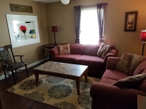 The Living Room with chair, Sofa, Loveseat, and 50" High Def TV