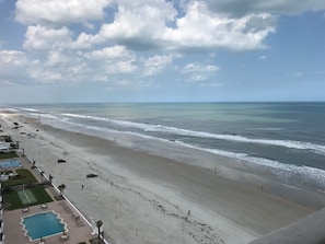 View of sandy beach in front of our building and condo looking north