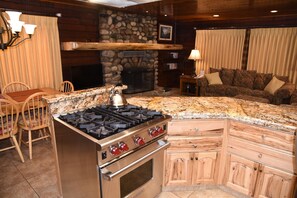 Gourmet kitchen with stainless steel appliances, Wolf Range, granite counter tops