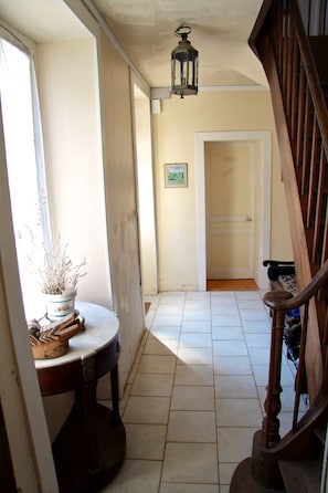 Hallway entrance. Stairs go to second floor where five bedrooms are located