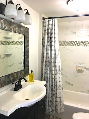 Full bath with custom tile.