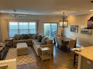 Living room with kitchen table and adjacent kitchen space