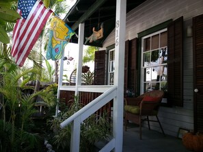 Front Porch with 2 chairs and swing.