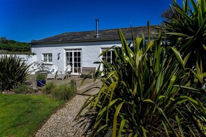 Walled garden, decking and lawn extending the front of the property