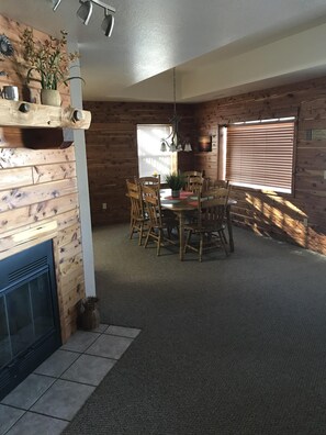 View of Dining Room from Living Room - Real wood burning Fireplace on the left.