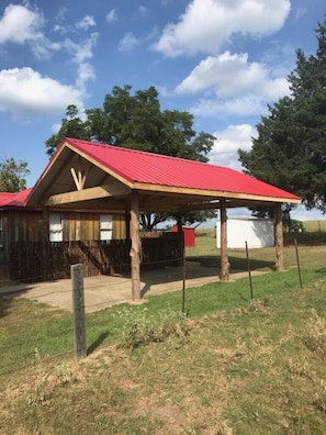 Pavilion for group gatherings with electric outlets, lighting, and a fan. 