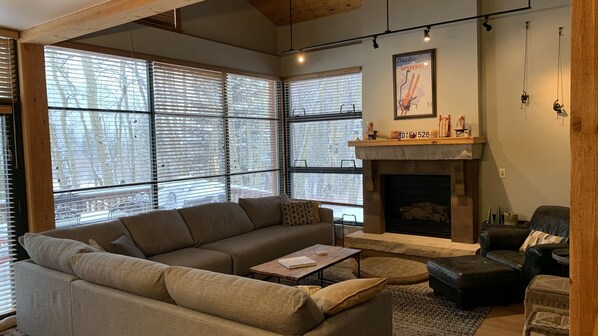 Bright and sunny living room with large sofa and arm chair