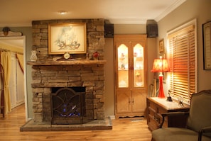 Native stone gas-log fireplace in living room