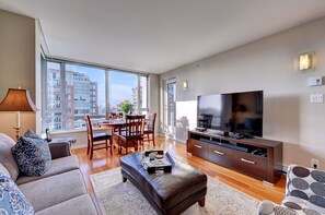 Living Room with comfortable couch & chair, 52 inch Smart TV & Premium Cable Pkg