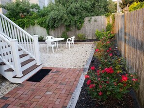 walk around side of property, roses to your right and enter your backyard