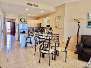 There is seating at the table for 4 and 3 counter stools. 