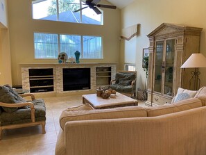 Living room/great room lots of light looking out towards pool area &open kitchen
