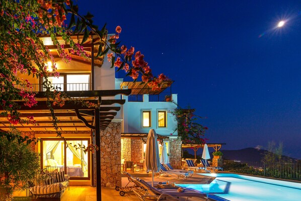 Villa and pool at night time