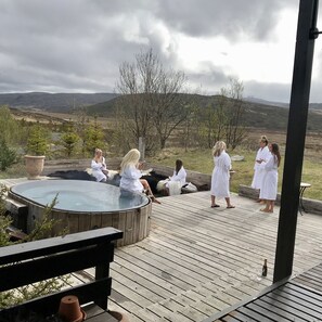 Hot tub and patio in front of house