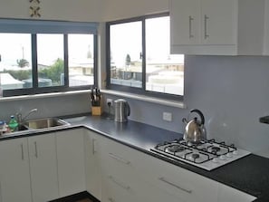 Kitchen with a view to the jetty and over the bay.