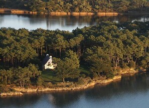 The house nestled between the woods and the sea