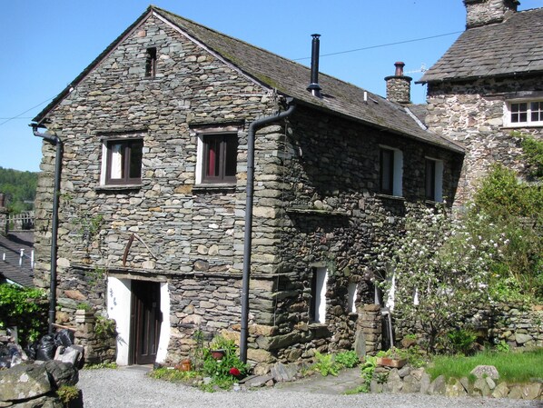 How Head Barn, including parking forecourt, showing entrance to accommodation.