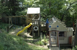 Children's playground & playhouse (on property) in front of house lakeside.
