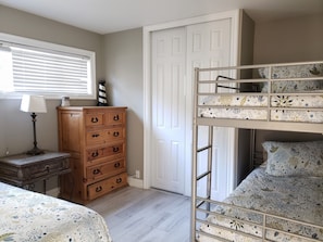 2nd bedroom with one twin bed and a set of bunk beds