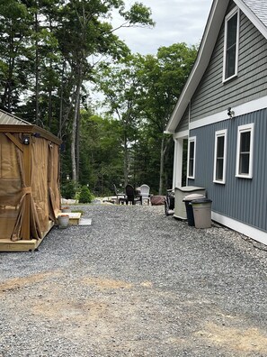 Side view of home with gazebo, rubbermaid shed w/ extra camping chairs for beach