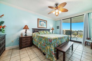 Primary suite with spa-like bath and balcony overlooking the bay