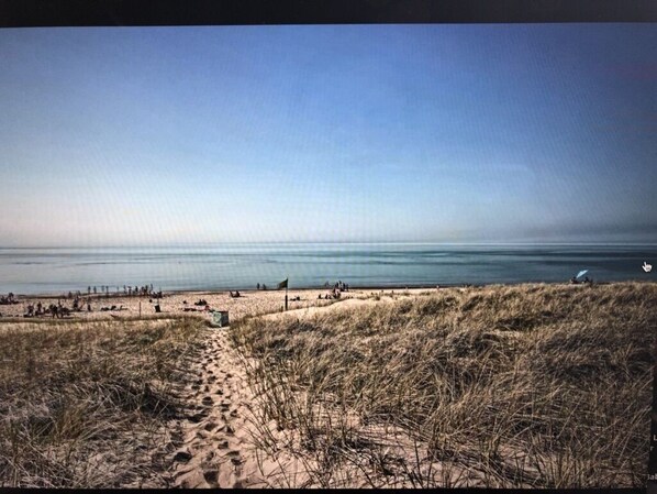 True lakefront property, steps to beach with giant lush grass backyard