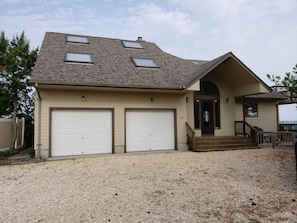 Driveway holds several cars.  View from the road