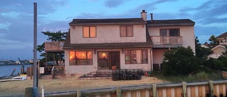 View from the end of our dock on the bay.  Sunset reflection in windows
