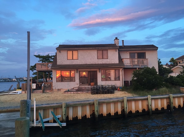View from the end of our dock on the bay. Sunset reflection in windows