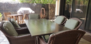 Enjoy outside family gatherings near the pool side in the spacious dining area.
