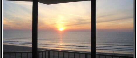 View of the sunrise from the living room through the sliding glass doors 