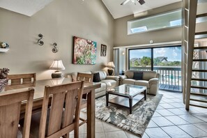 Living area leads out to covered deck overlooking pool