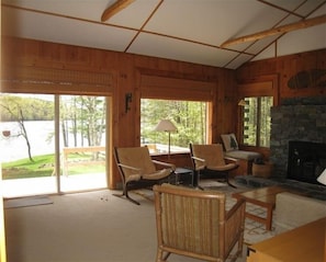 Living room, with stone fireplace and views of the river.