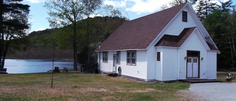 Front of house with private lakefront in back.