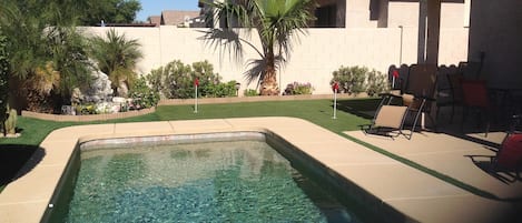 Relaxing backyard with fountain and putting green