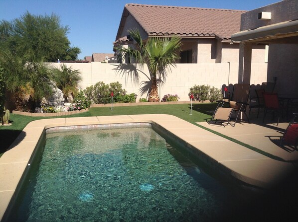 Relaxing backyard with fountain and putting green