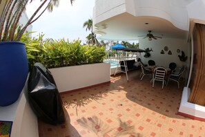 Seating area in Outside Patio. Table with 6 chairs and  comfortable swing chair.