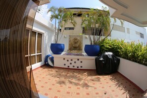 Front patio with coral stone  water fountain and  barb-b-q. Steps to pool.   