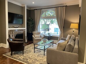 First floor living space with 55" smart TV and switch-operated fireplace.