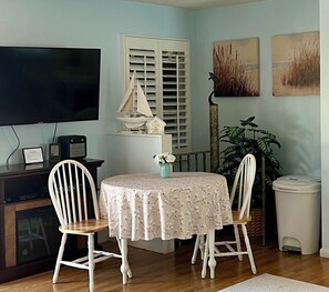Table and chairs for  dining indoors.  50-inch Smart TV for your entertainment. 