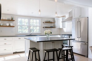 Spacious kitchen overlooking patio, pool, and yard