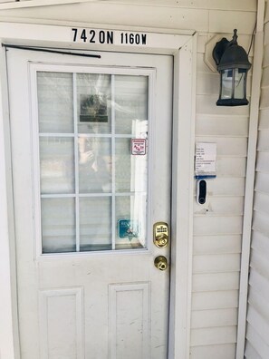 Front door with doorbell camera and keyless lock