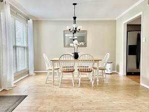 Chic dining room with table and six chairs with a view of picturesque backyard