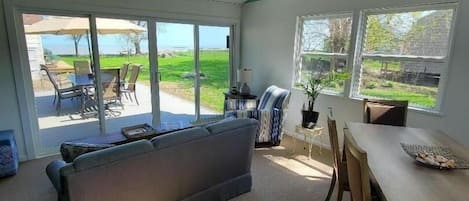 Additional living space in the sun room with lake views.